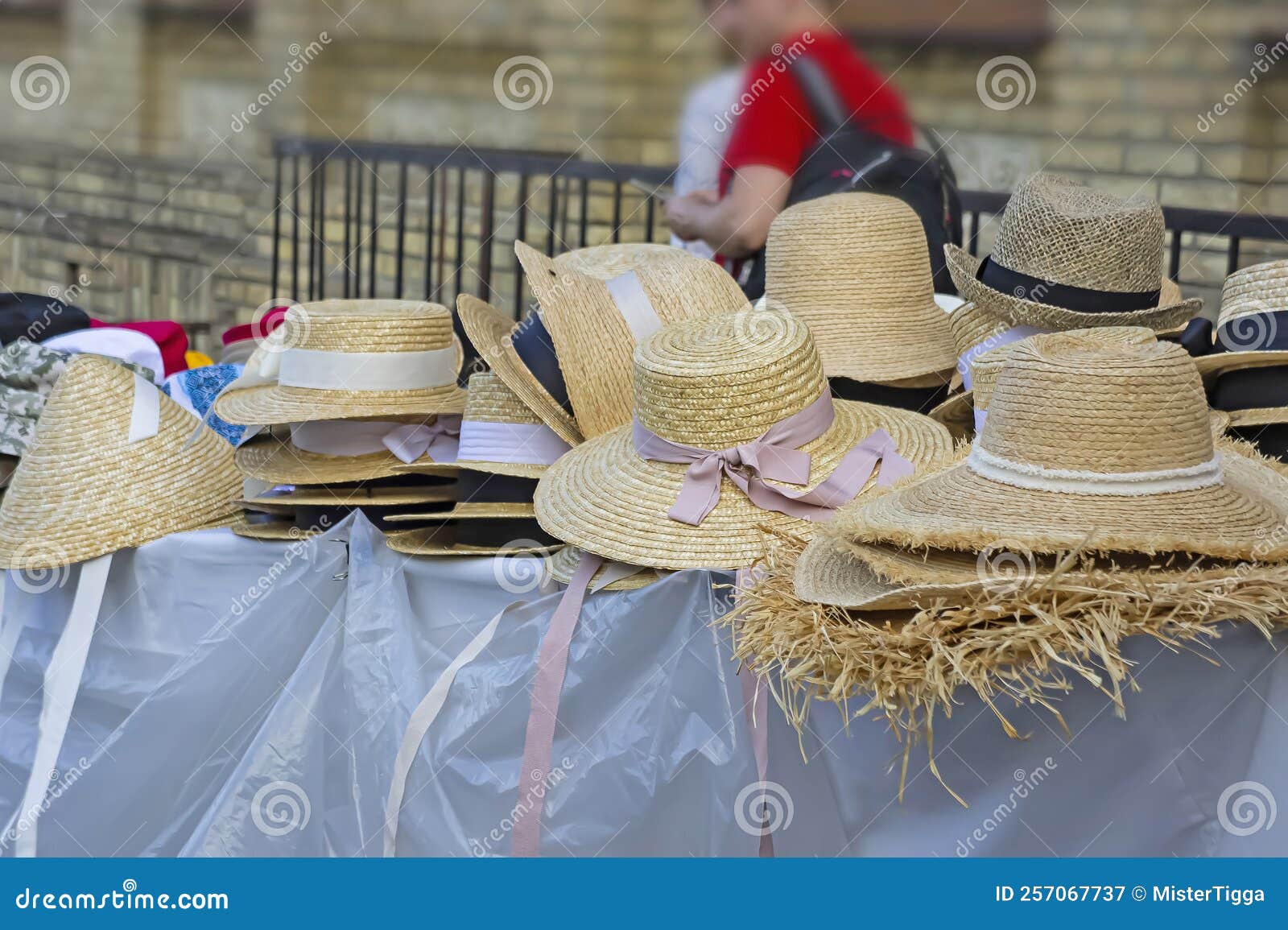 market stall with straw hats. big group of authentic panama hats or paja toquilla hats made from straw at craft market img