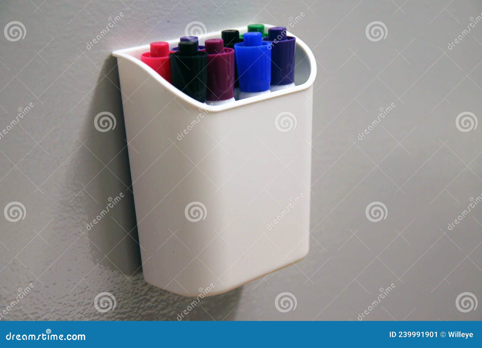 The Marking Pens in Their Container Hanging on a Erasable Grey Wall