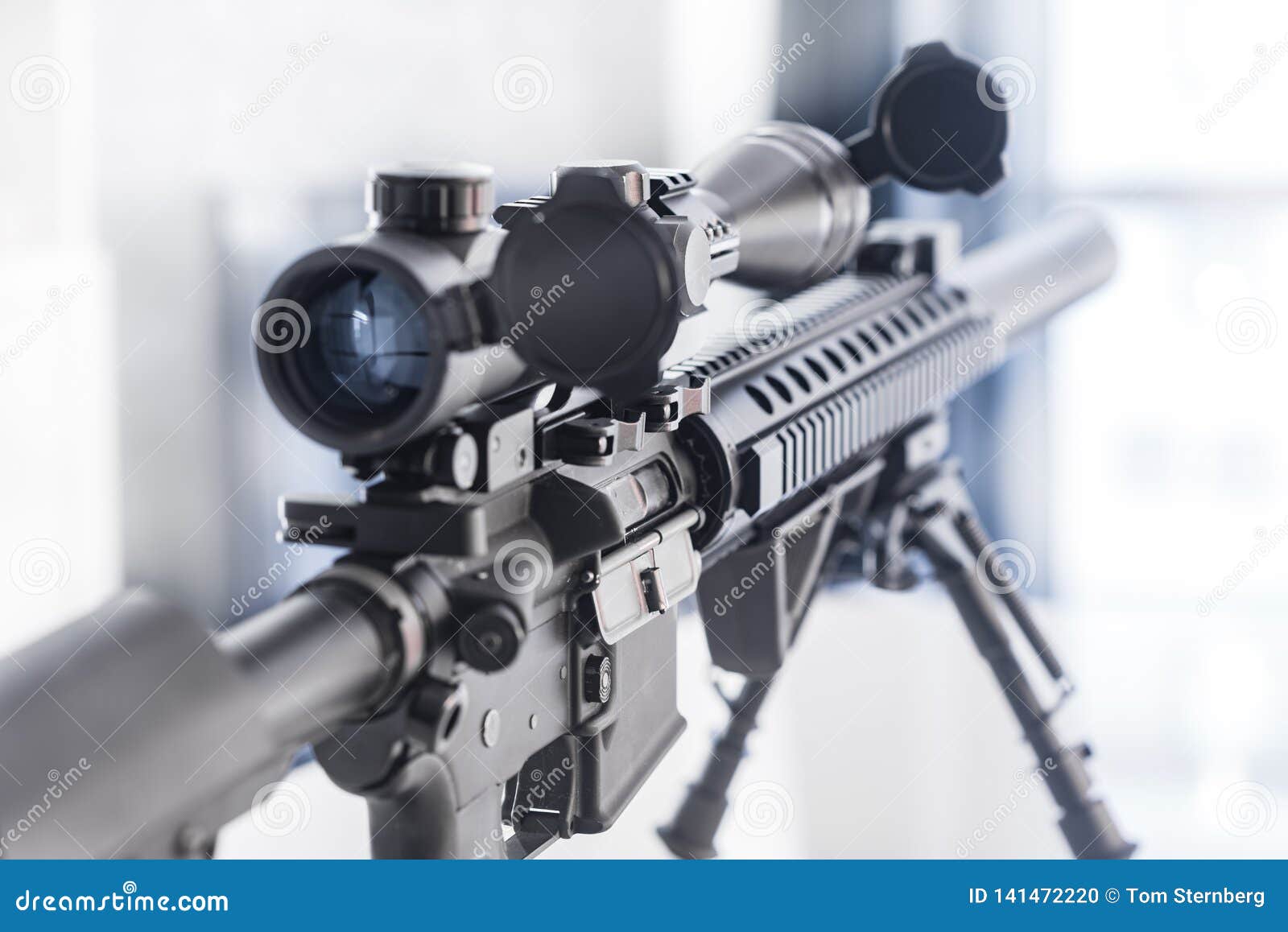marksman rifle with bipod on table