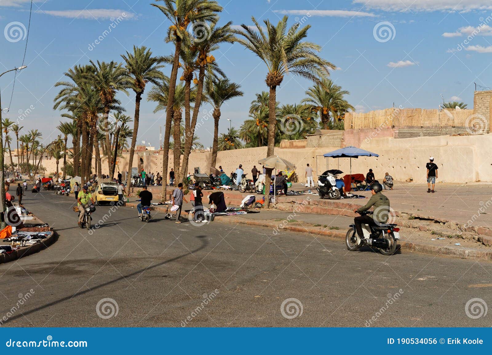 Marrakech Marocco Okt 7 18 Street Market On Sidewalk Blue Sky With Old City Wall And Palm Trees People Try To Sell Editorial Photo Image Of Shop Food