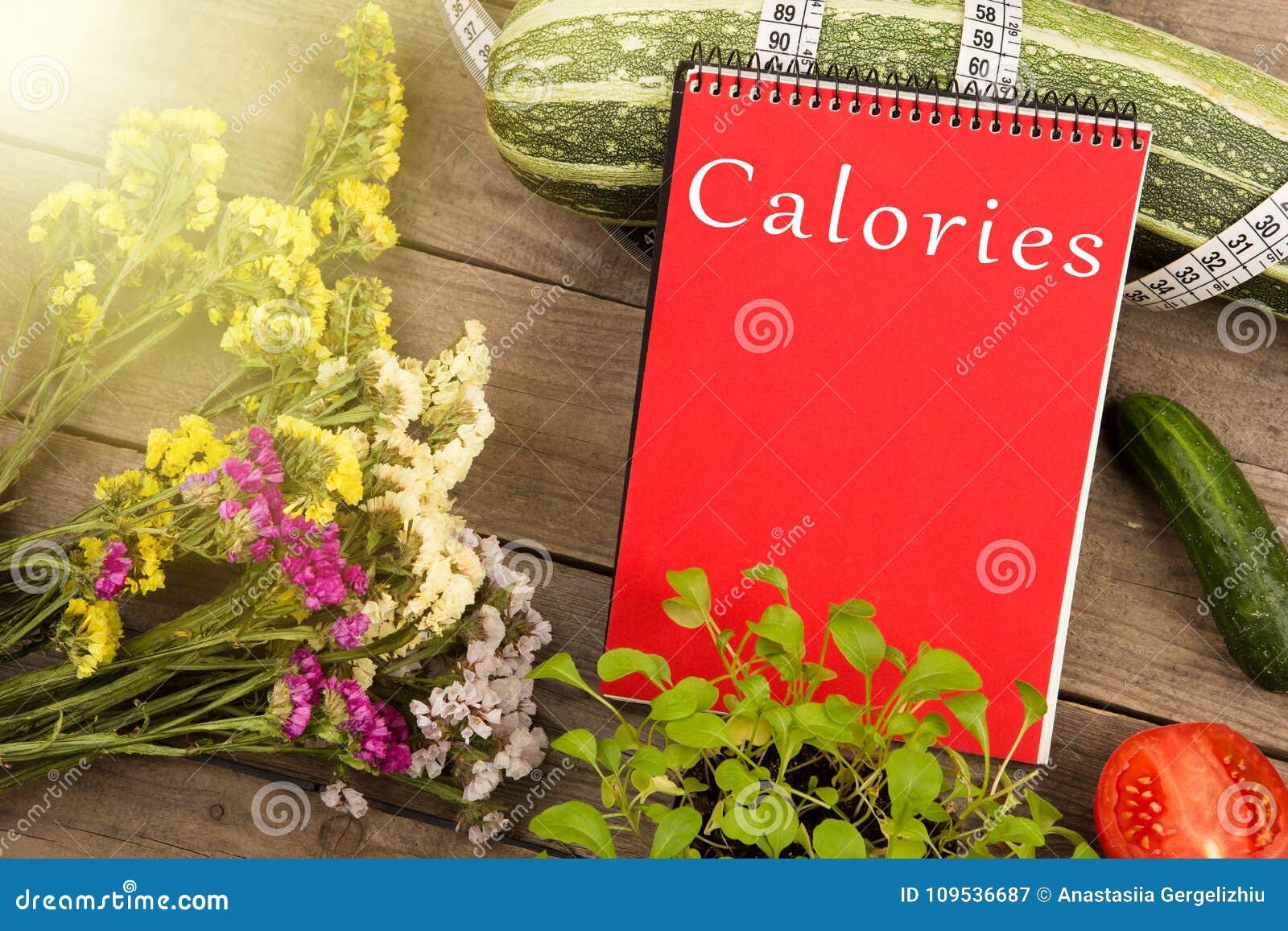 marrow squash, measure tape, red notepad with text & x22;calories& x22;