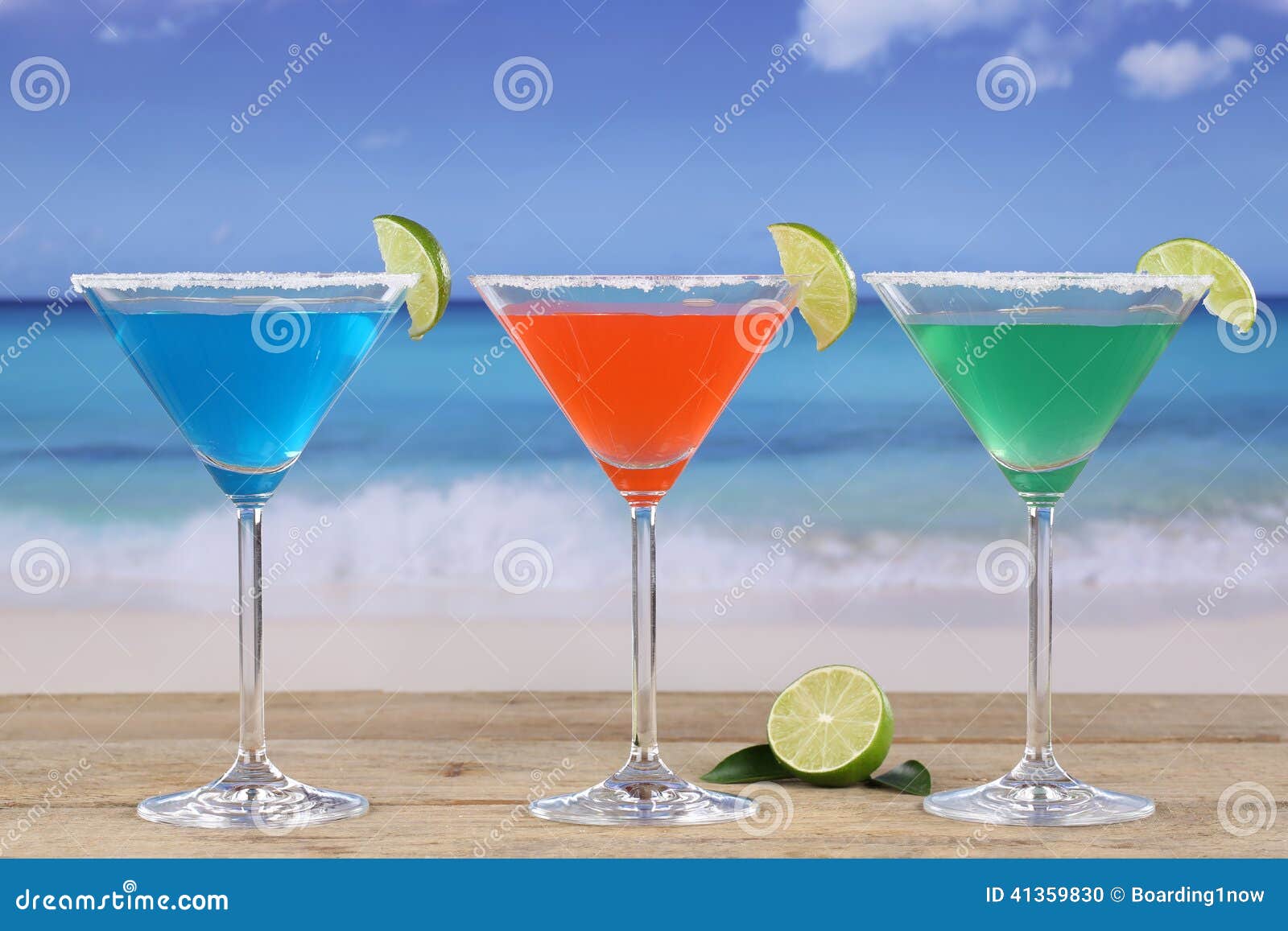 Martini Cocktails in Glasses on the Beach with Lemons Stock Photo