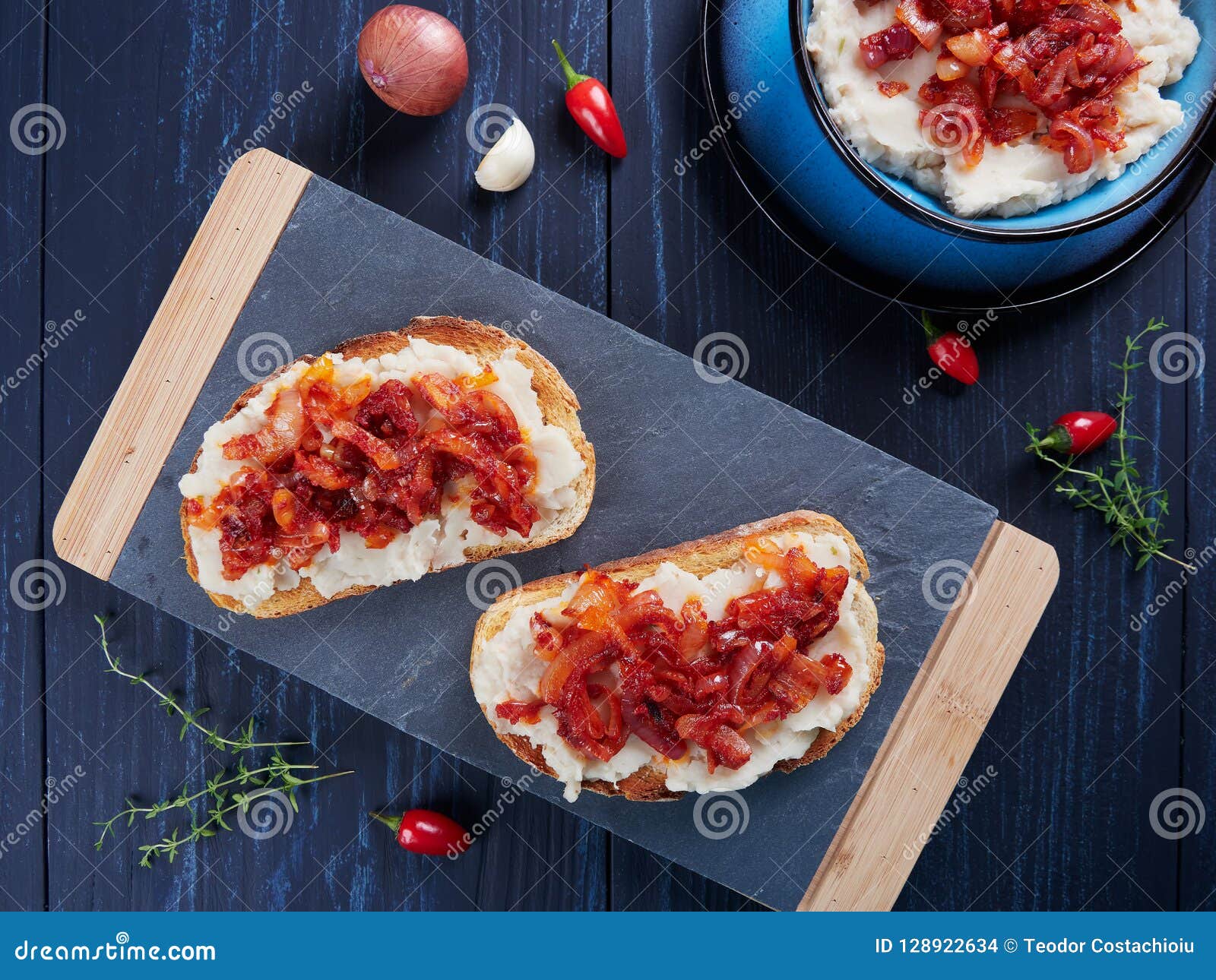 mashed beans spread with garlic and vegetable oil, with a topping of sauteed onions and tomato paste romanian: fasole batuta
