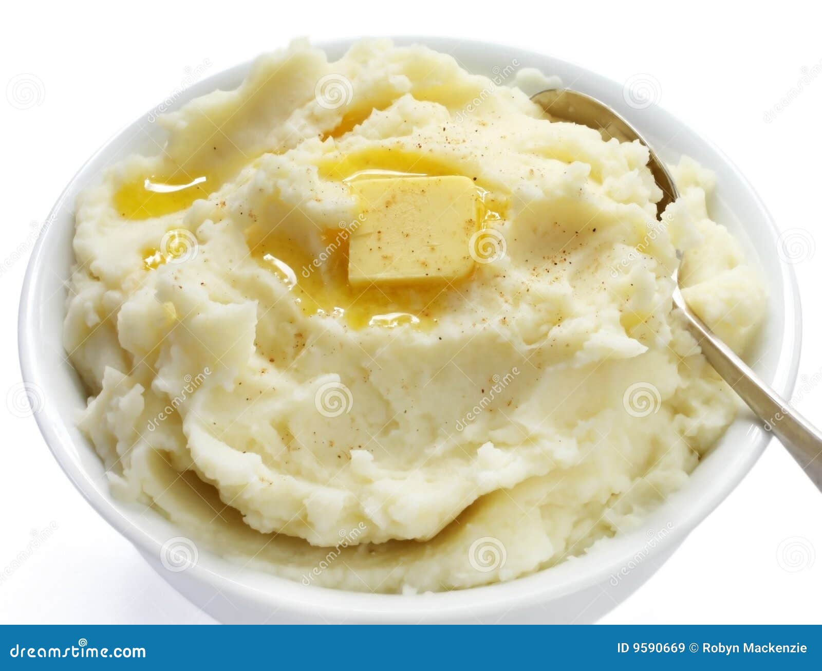 Bowl of mashed potato with melting butter and a sprinkle of nutmeg.