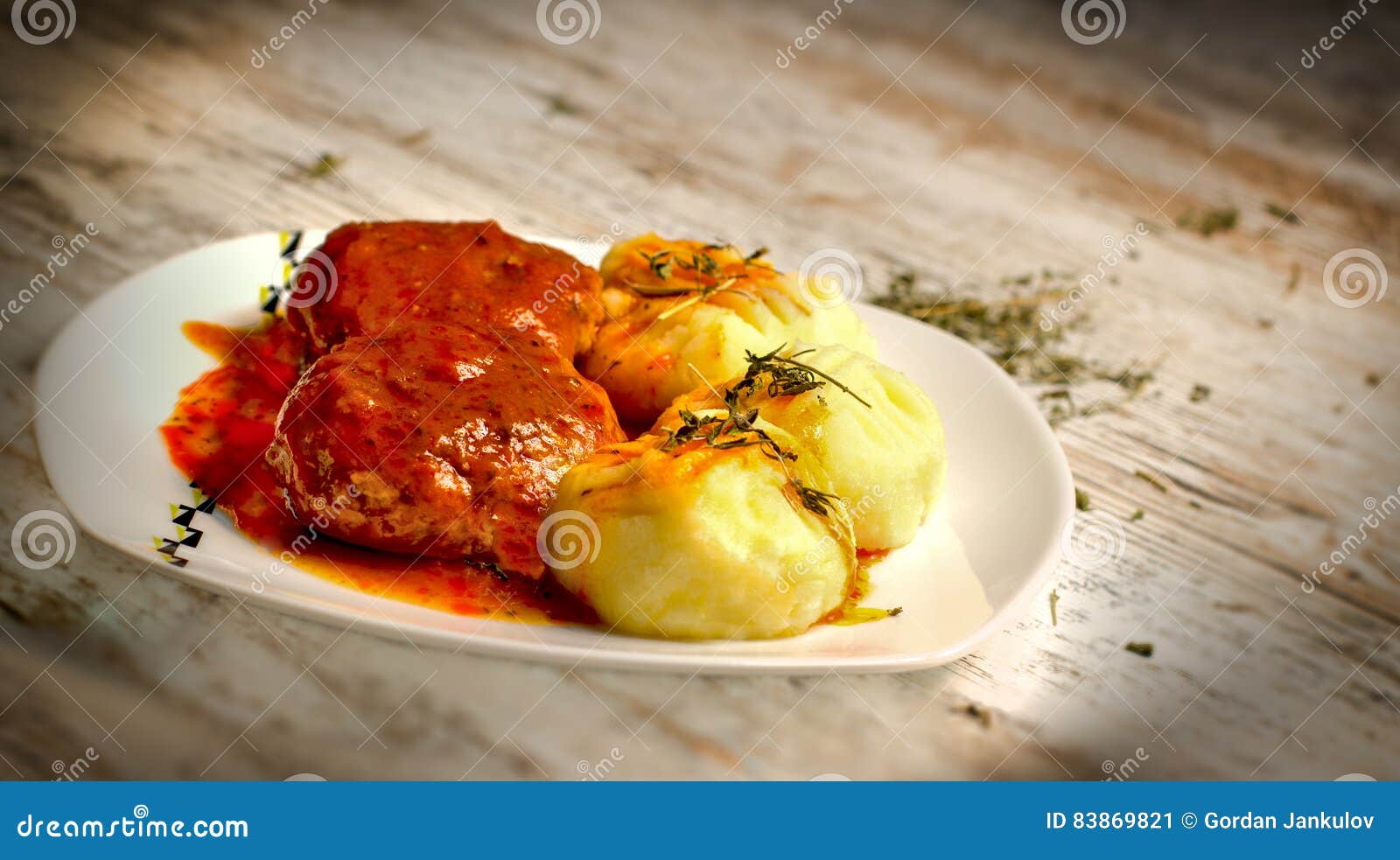 Mashed Potatoes and Meatballs with Tomato Sauce on White Plate Stock