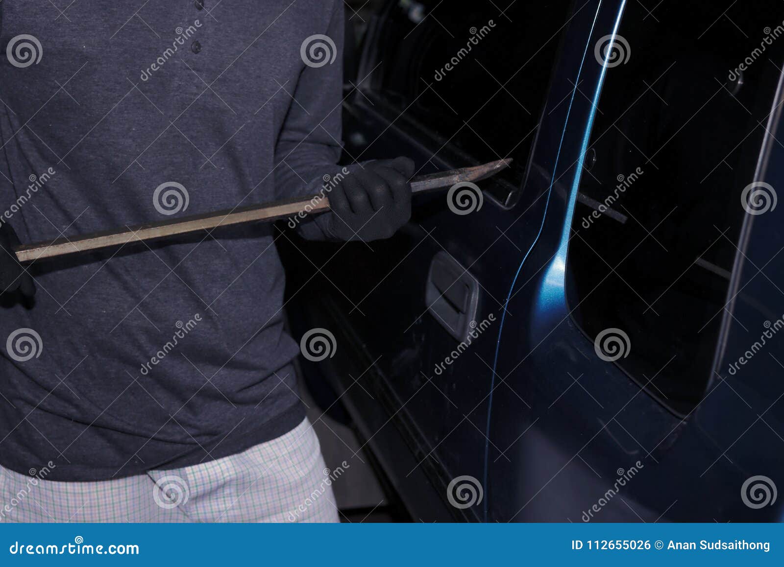 Masked Thief with Balaclava Using Crowbar To Breaking into a Car. Crime