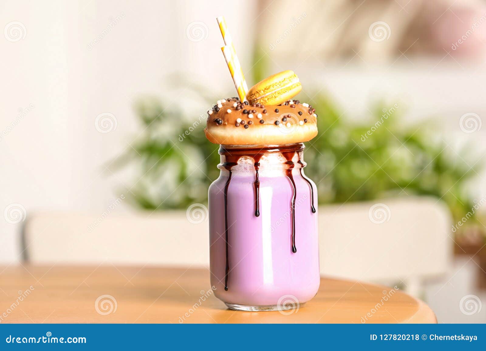 mason jar with delicious milk shake on table