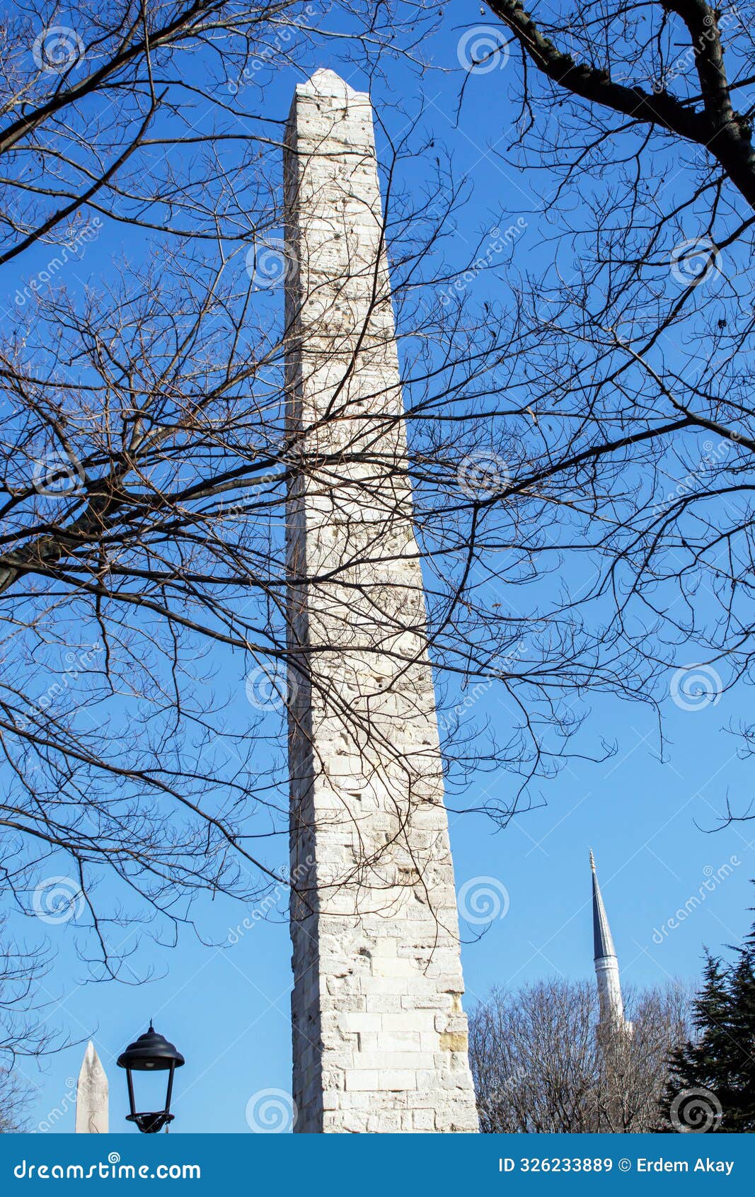 the masonry obelisk between bare tree branches, roman, byzantium empire