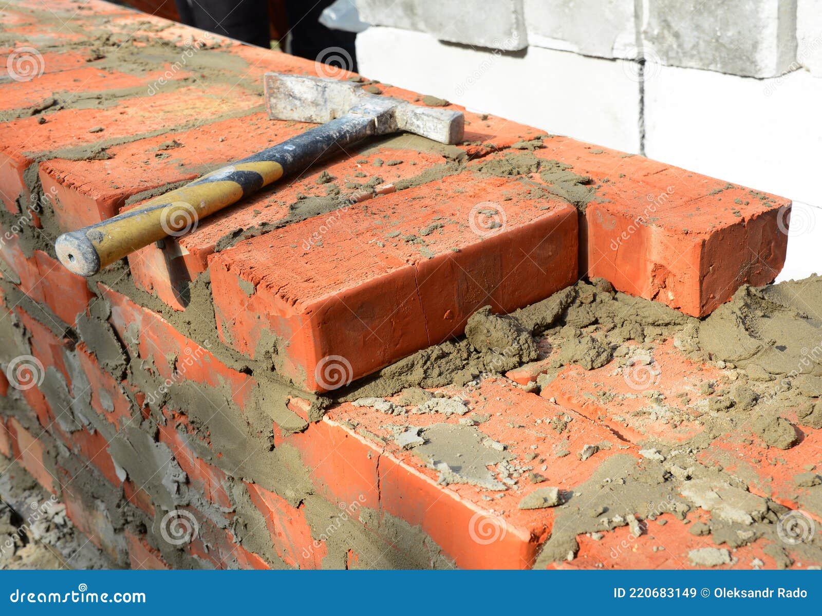 Masonry Tools And Equipment. A Closeup Of A Masonry Wall Construction Using A Bricklayer`s