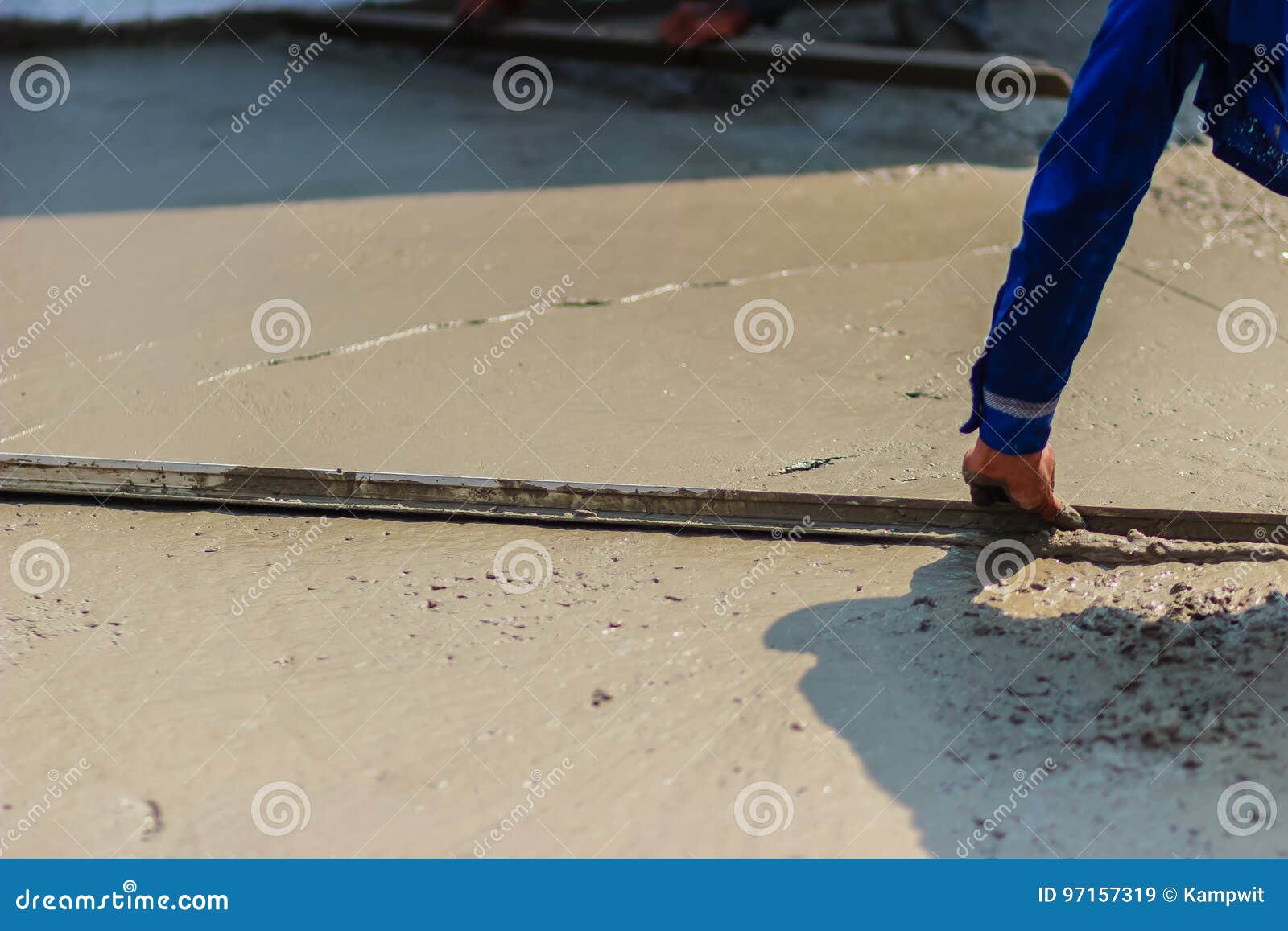 Masonry Worker is Using Long Trowel To Smooth or Leveling Concrete Flooring Work Step of the