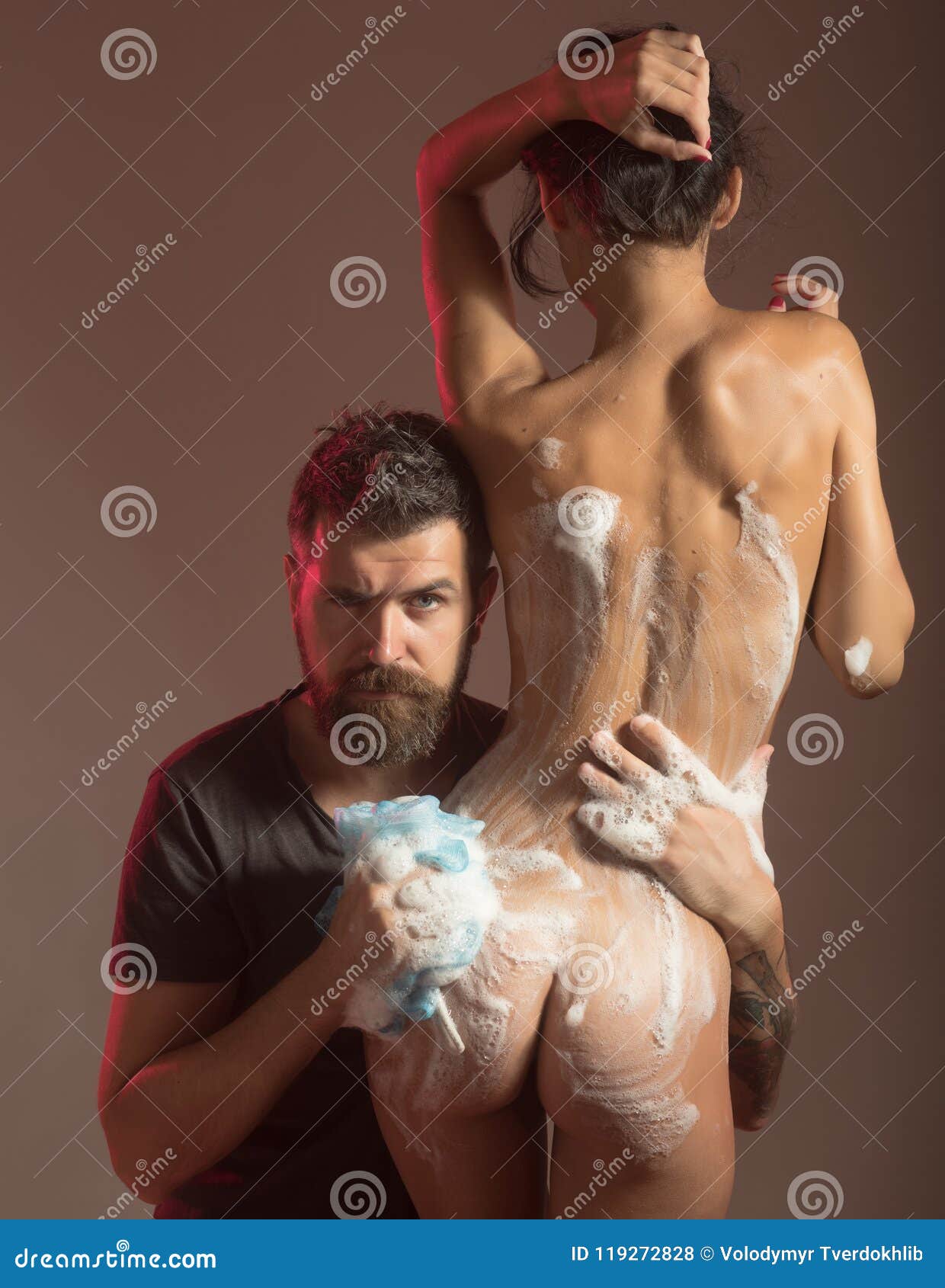 Massage and Family Spa Concept. Bearded Man Wash Naked Woman with Wisp