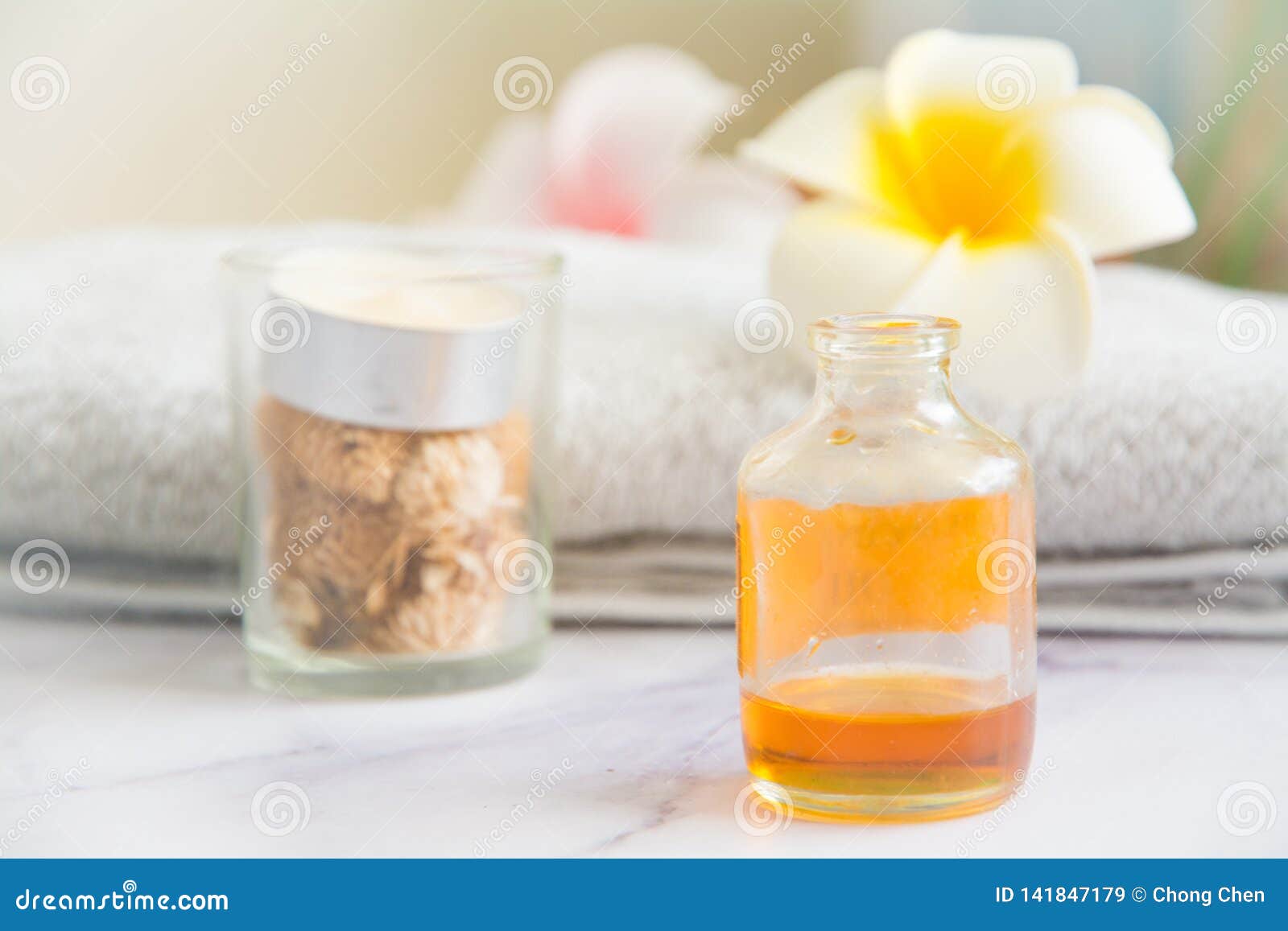 Massage set with Cinnamon essential oil massage. Massage set with Srilanka cinnamon essential oil, candle, towel and egg flowers. Landscape with eye level shot.