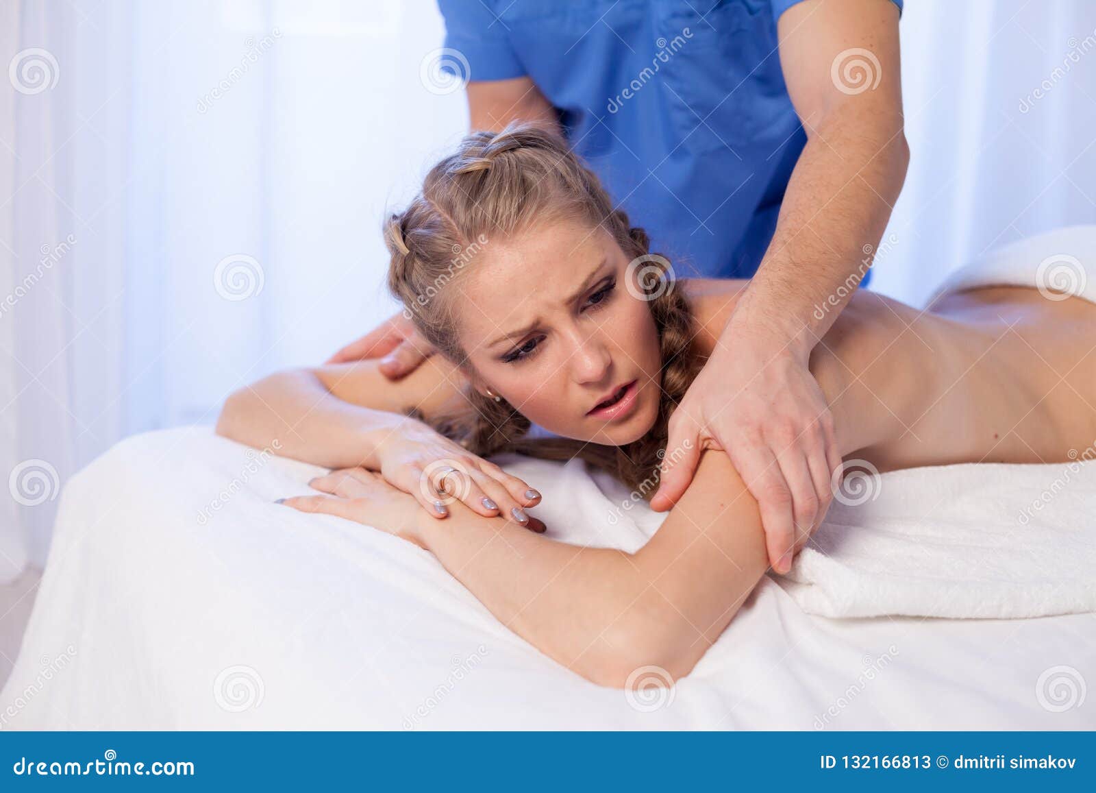 A Massage Therapist Makes A Beautiful Woman Medical Back Massage And