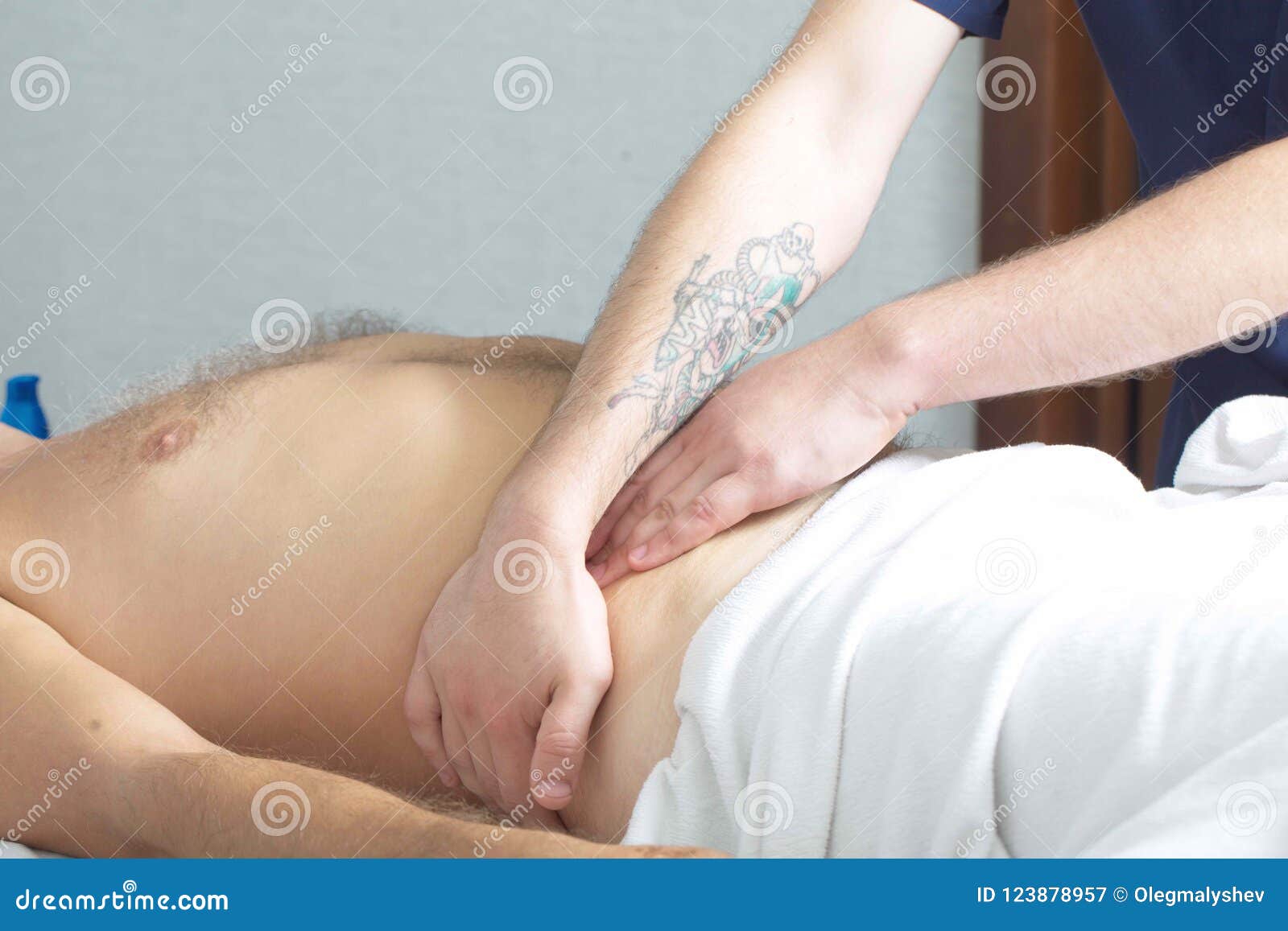 Massage Therapist Makes A Man A Massage Stock Image