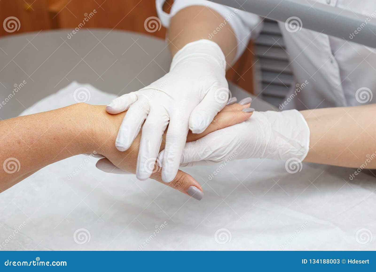 Massage Therapist Massaging Hands Of A Woman In A Beauty Salon Stock