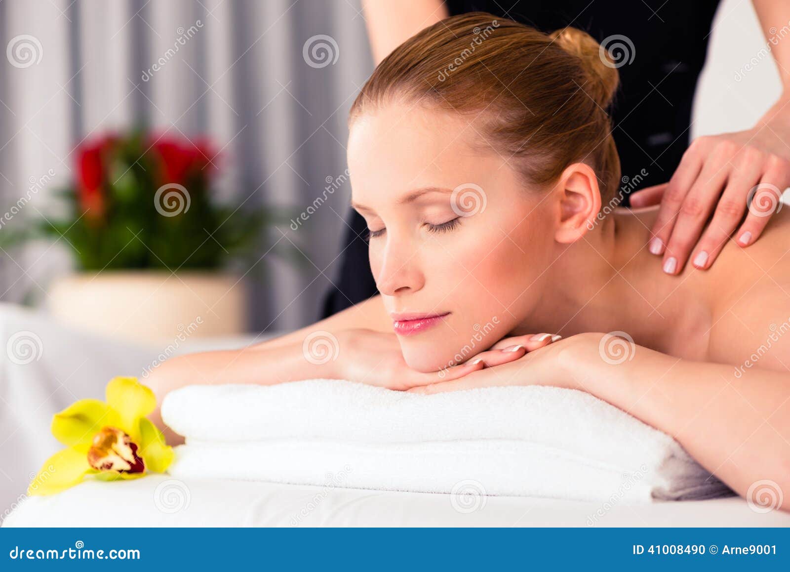 massager giving woman wellness spa massage