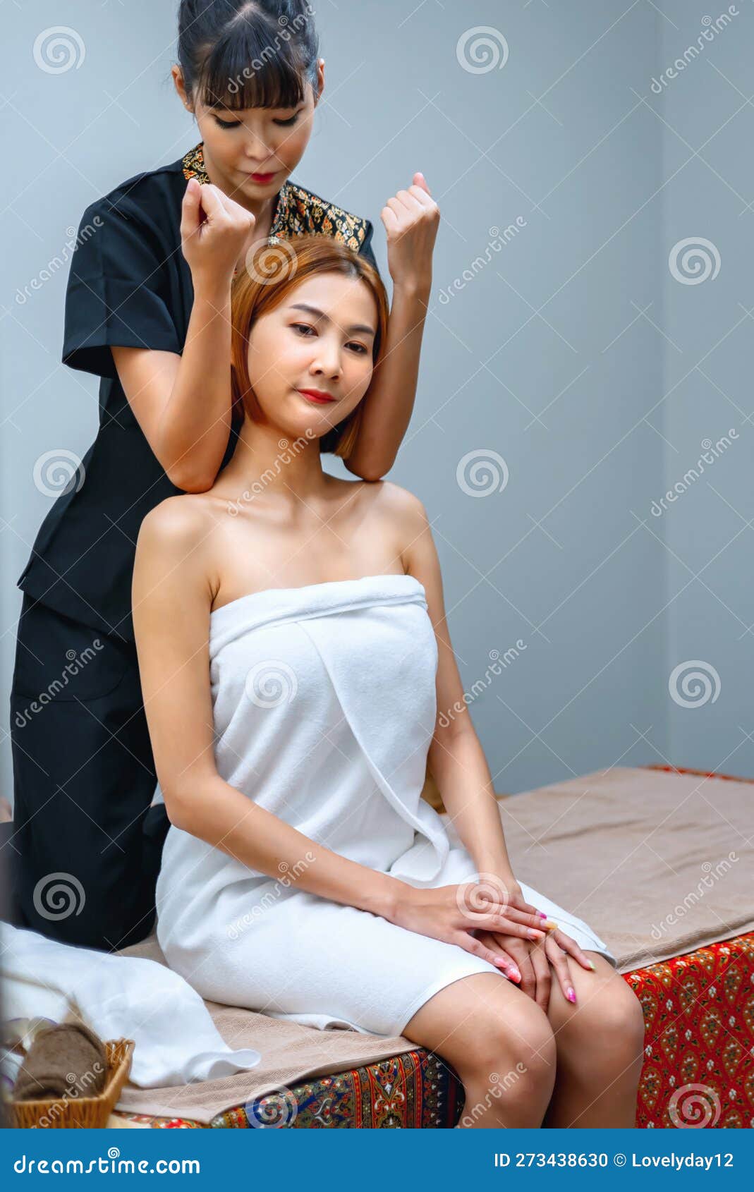 massagist tilting woman head while pressing elbow.thai massage in spa