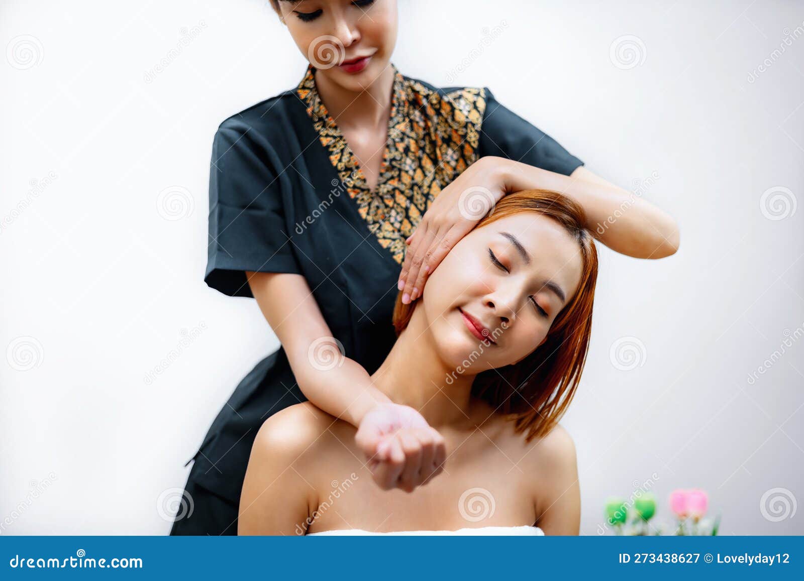 massagist tilting woman head while pressing elbow.thai massage in spa