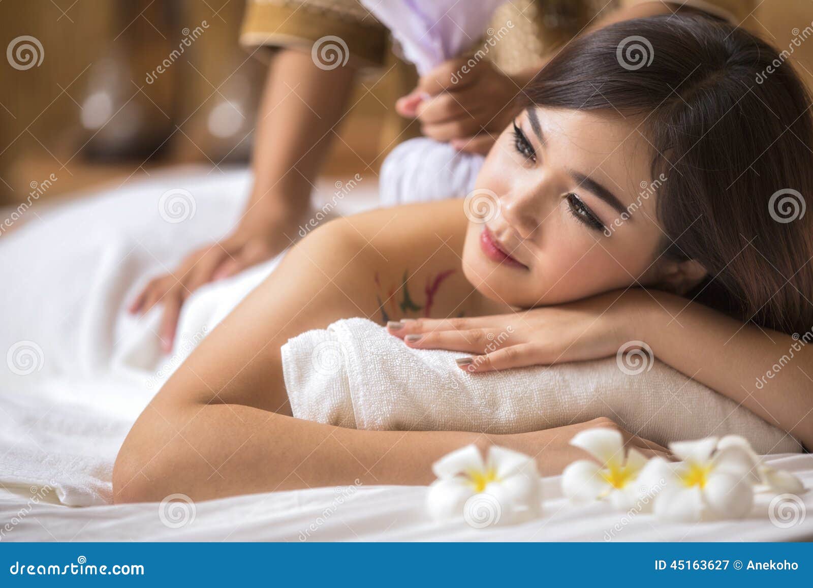 masseur doing massage on asia woman body