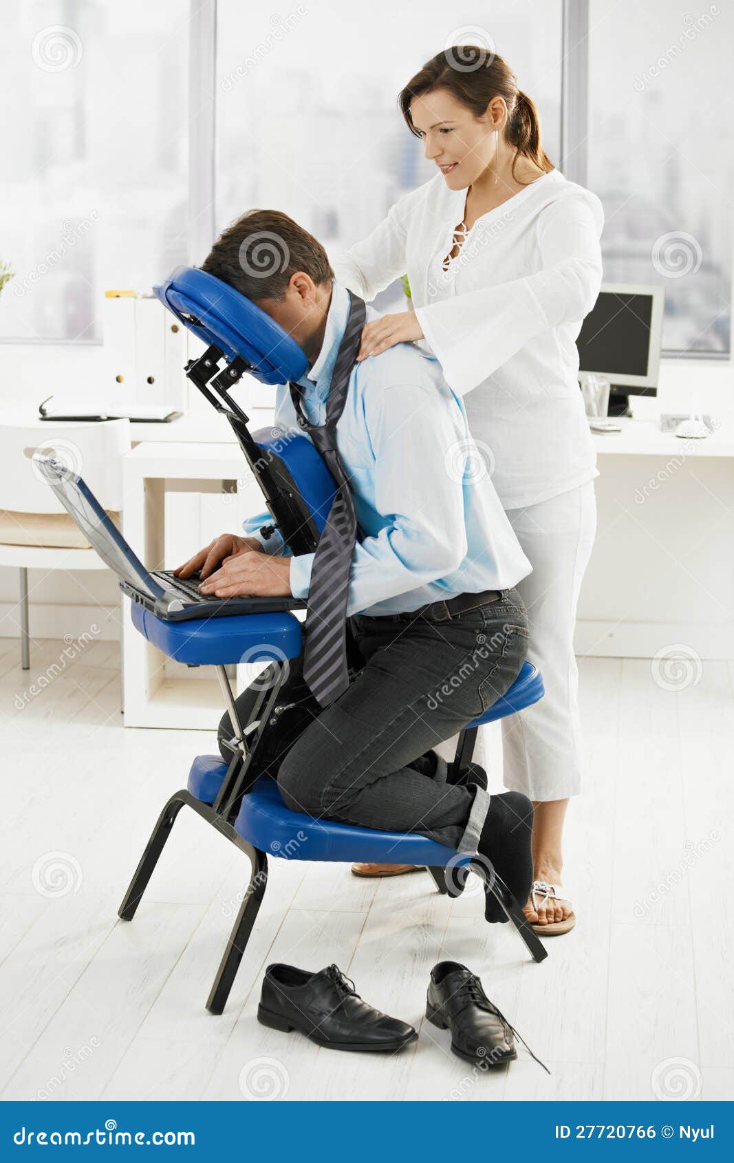 masseur doing neck massage in office