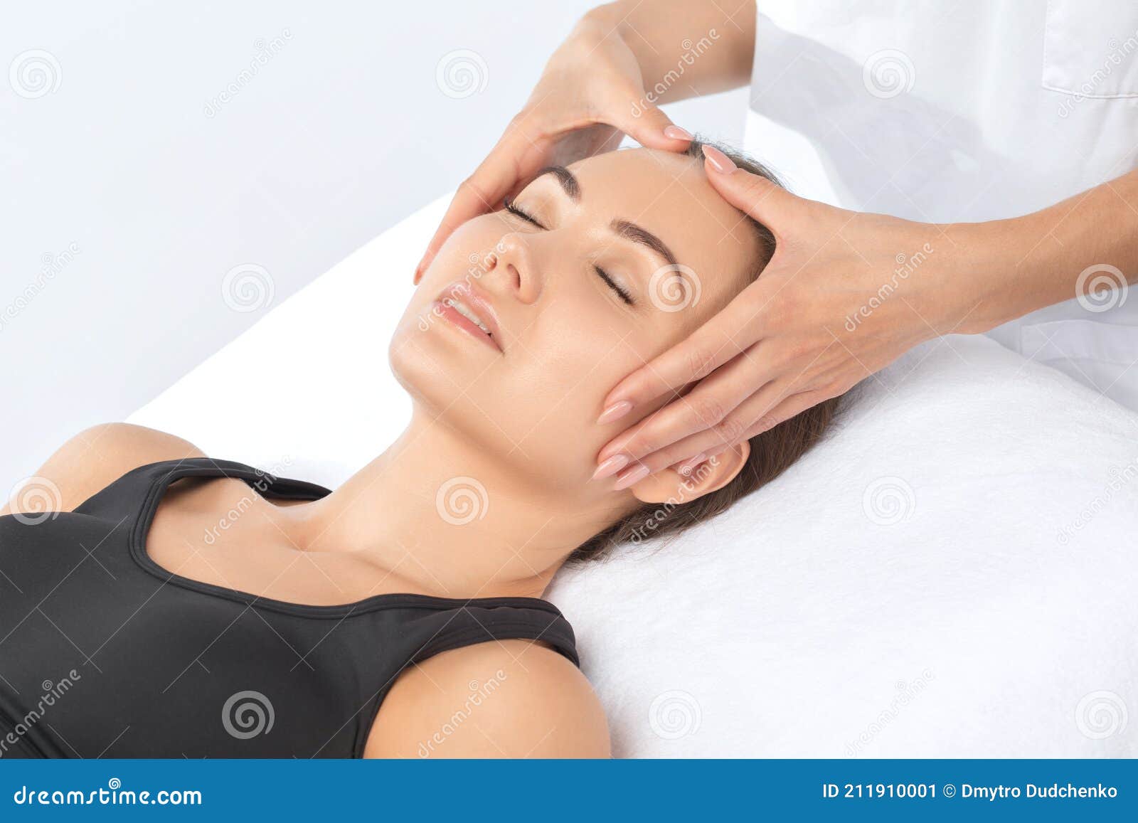 Masseur Makes A Relaxing Massage On The Face Neck Shoulders And Collarbones Of A Young