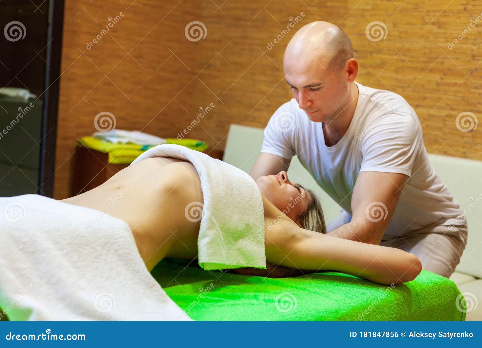 Masseur Works On Woman Arms Doing Traditional Thai Massage On