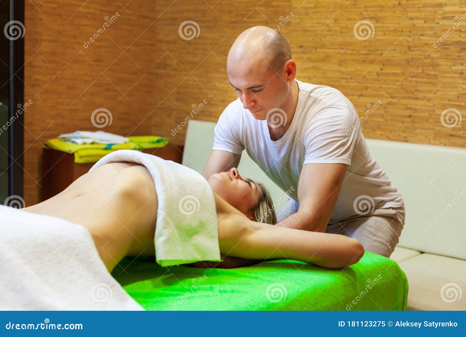 Masseur Works On Woman Arms Doing Traditional Thai Massage O