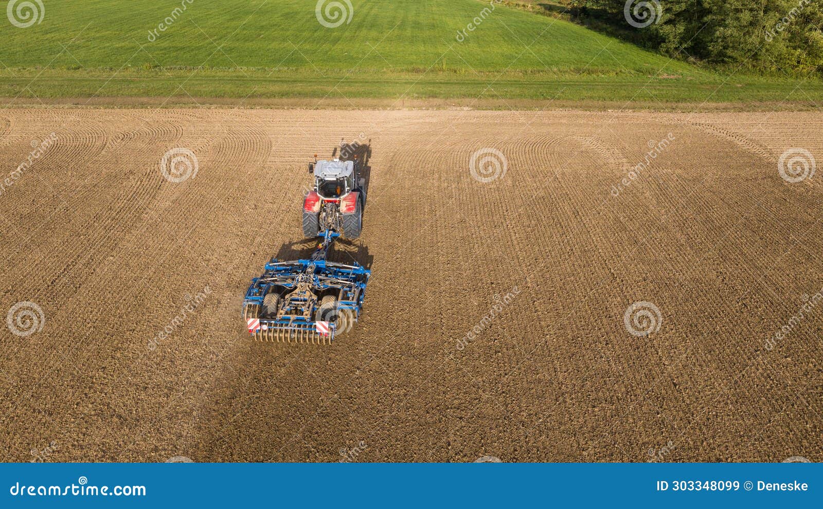 a massey ferguson velox ker 8s.265 tractor pulls the disc harrow through the field to prepare the soil
