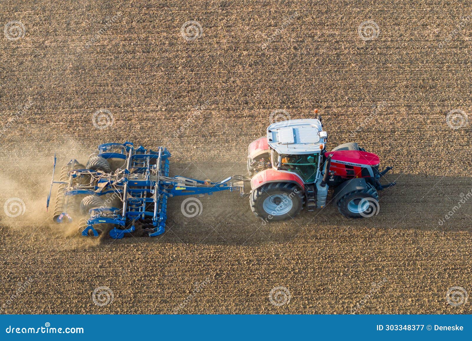 a massey ferguson velox ker 8s.265 tractor pulls the disc harrow through the field to prepare the soil