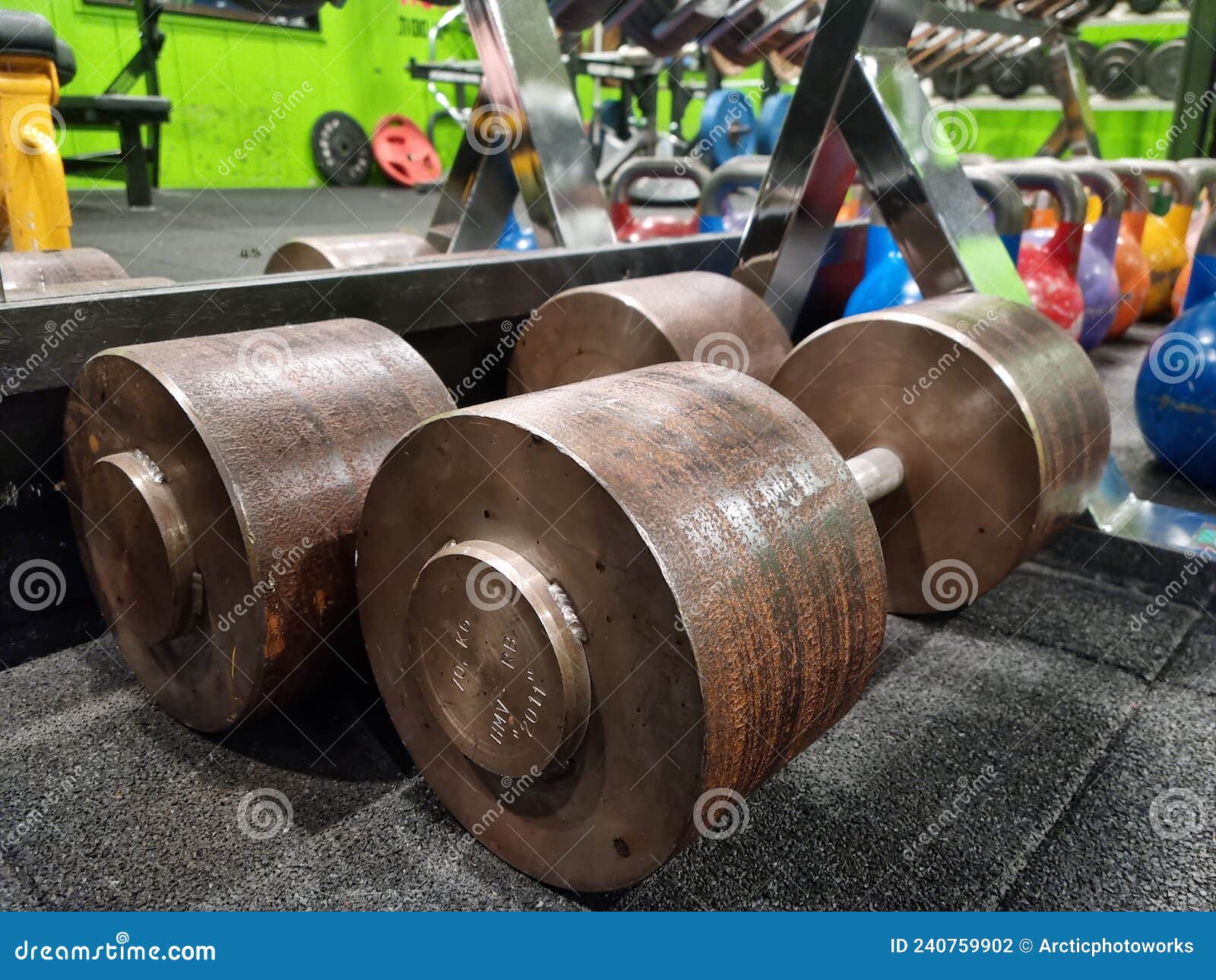 Massive Old Rusted Dumbbells on 70 Kilograms in the Gym Stock Photo