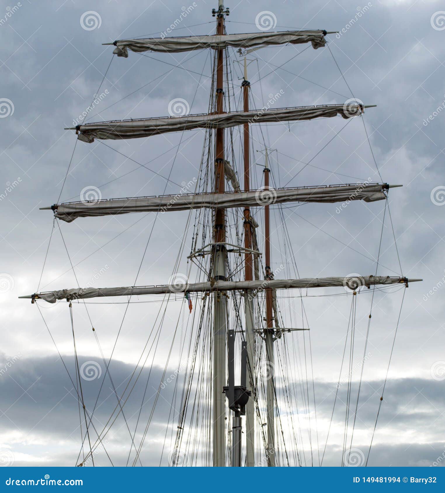 mast, rigging and furled sails on a tall ship / sailing ship