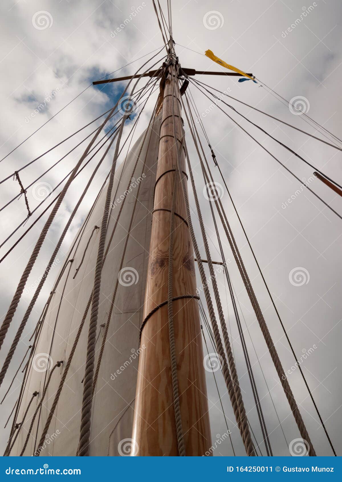 mast, ropes and sails collected from an old sailboat seen from below