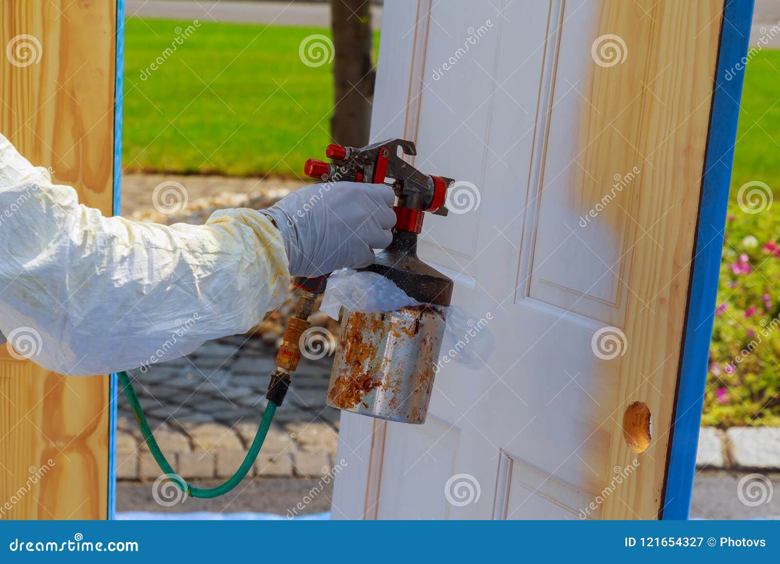 Master Painting Wood Doors Paint the Door with a Spray Stock Image
