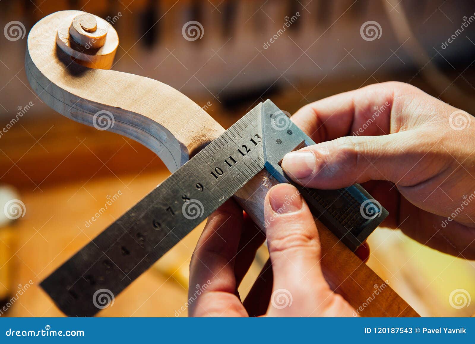 Master Artisan Luthier Working on Creation of a Violin Scroll. Detailed Work on Wood with Tools