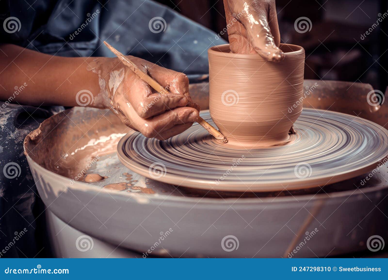 master-ceramist creates a clay pot on a potter's wheel. hands of potter close up. ancient craft and pottery handmade