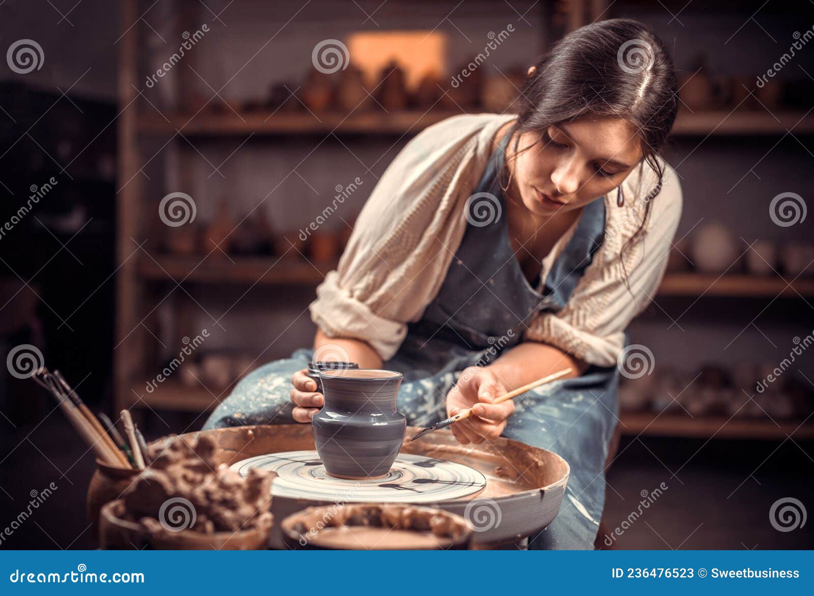 processing clay ware and making dishes, process. ceramics of handwork and clay ware on the potter& x27;s wheel.