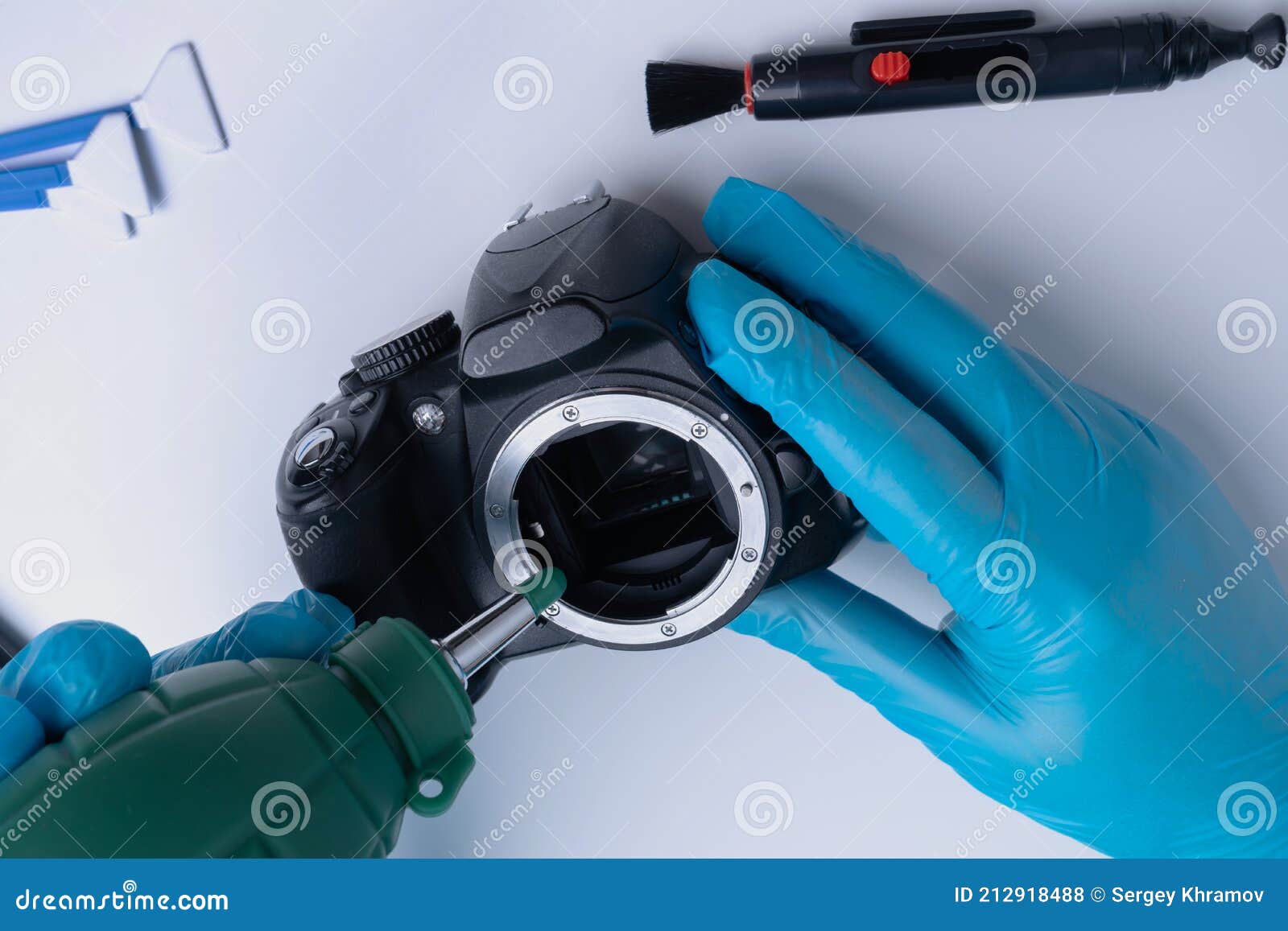 Master Cleans the DSLR Camera Sensor with a Blower Stock Photo Image
