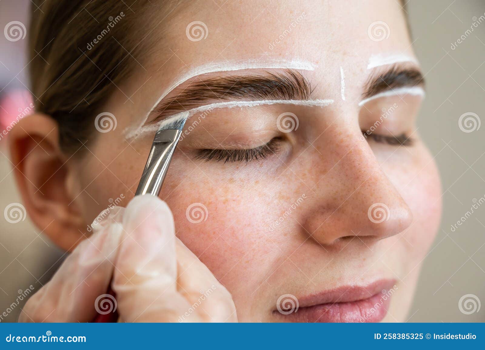 The Master Draws the Shape of the Eyebrows with White Paint before