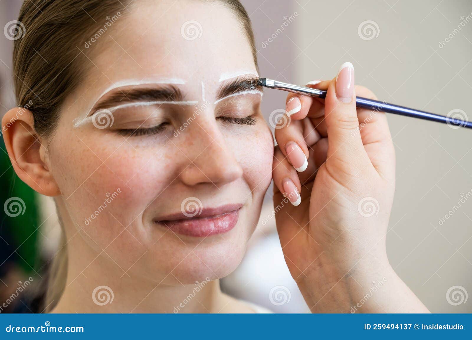 The Master Draws the Shape of the Eyebrows with White Paint before