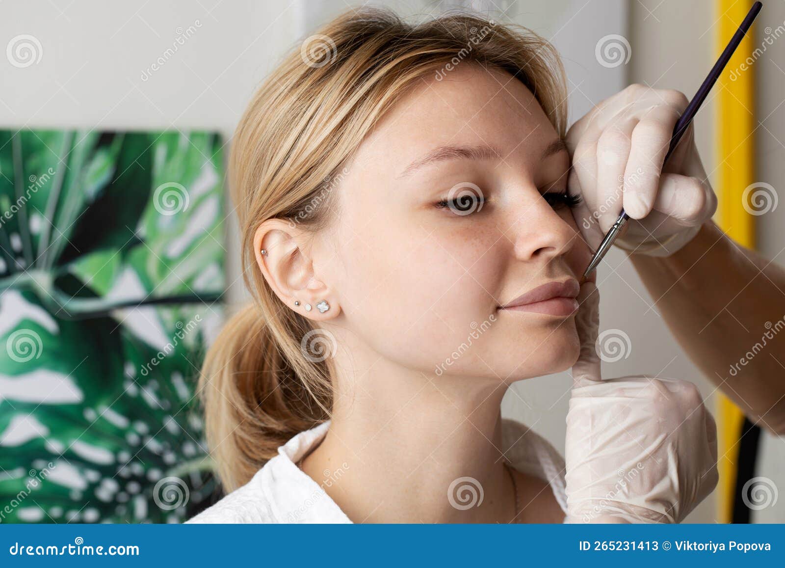 The Master Draws a Sketch before the Lip Permanent Procedure with a
