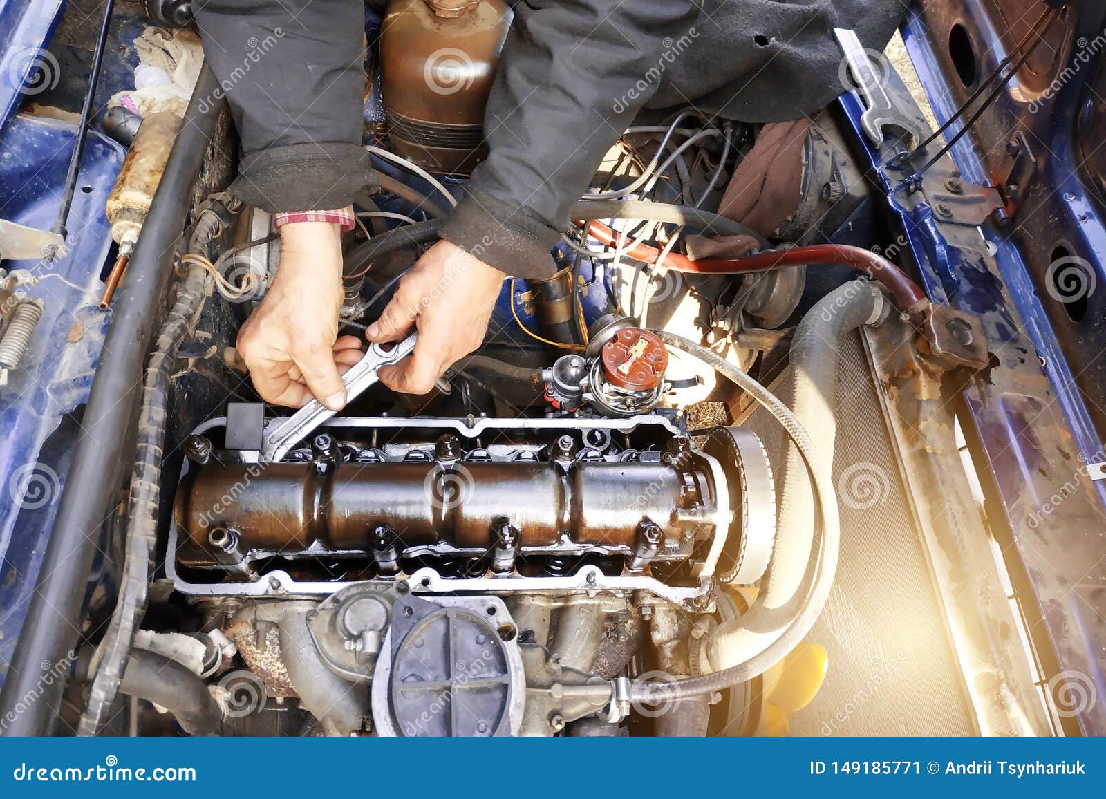 The Master in the Garage Taps the Valves in the Old Car, VAZ Car, an