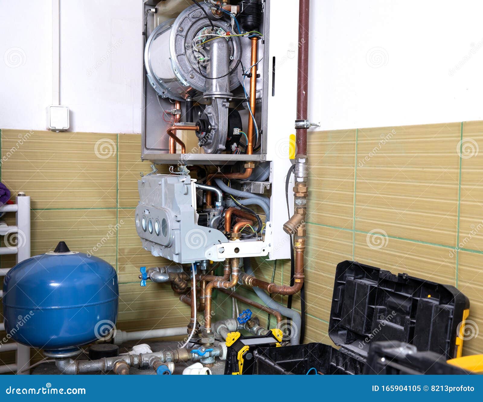 plumber fixing central heating system, worker servicing a gas boiler
