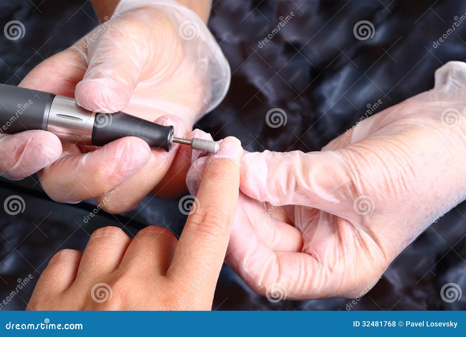 master in gloves uses an machine to remove the cuticle