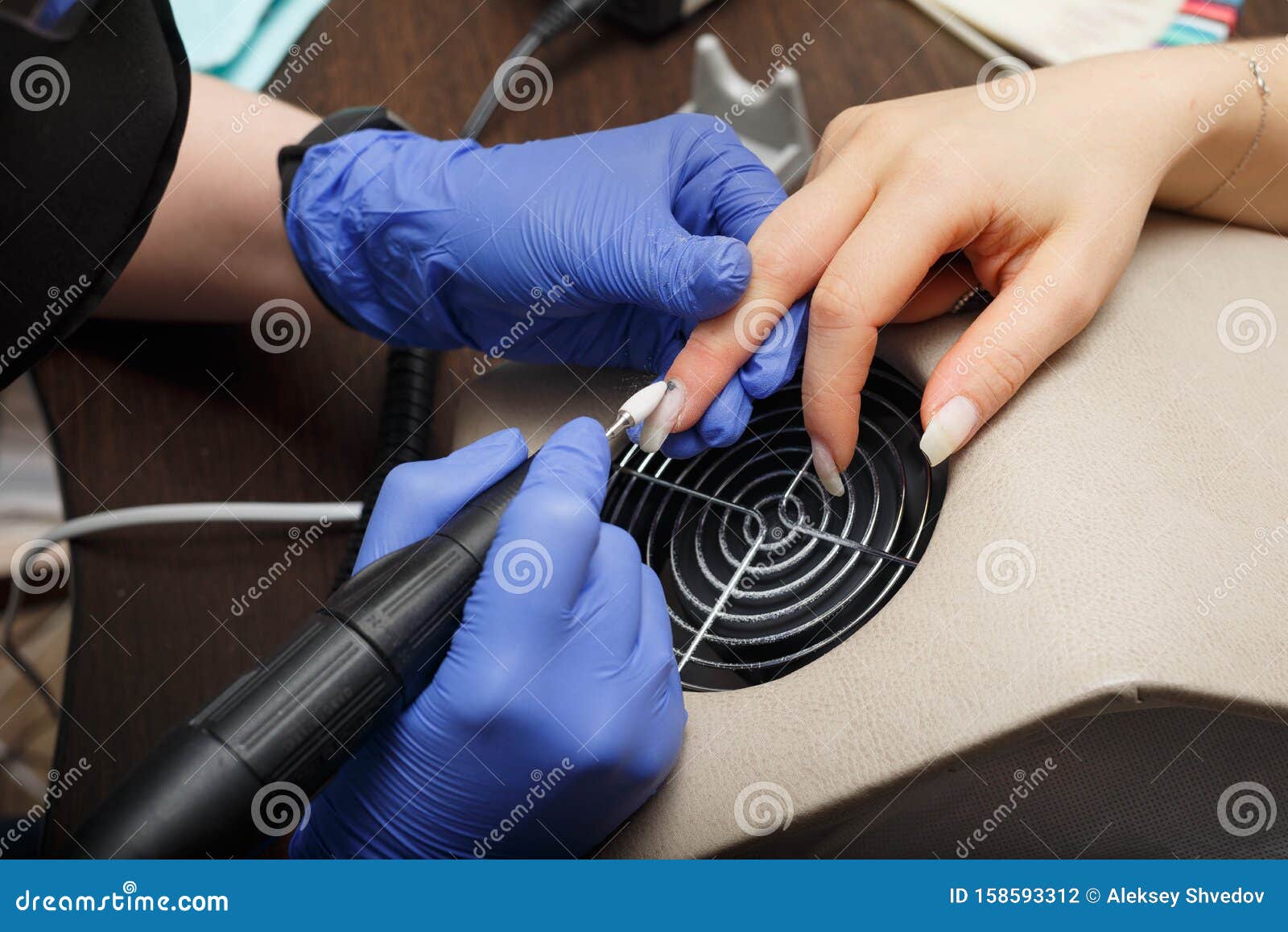 The Master of Nail Service Aligns the Nails To the Client with an