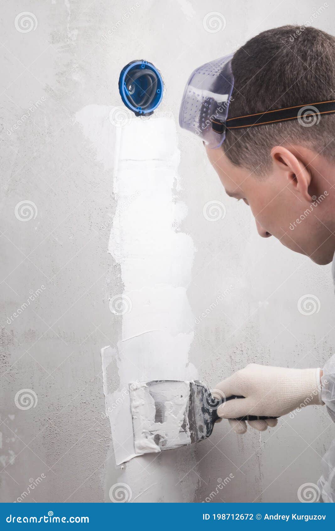 Master Plasterer Seals Electrical Wires for a Socket into a Concrete