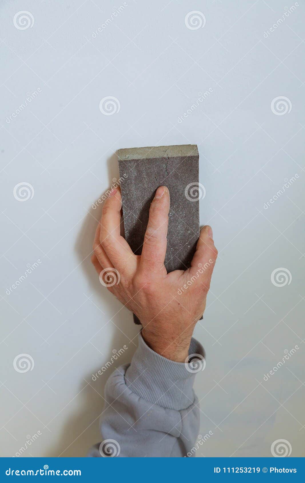 Master Plasterer Smooths the Seams with Plaster between Plaster Panels