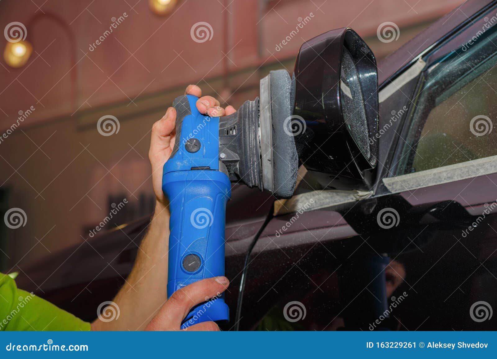 A Master Polishes a Car Mirror with a Paste Grinder Stock Image Image