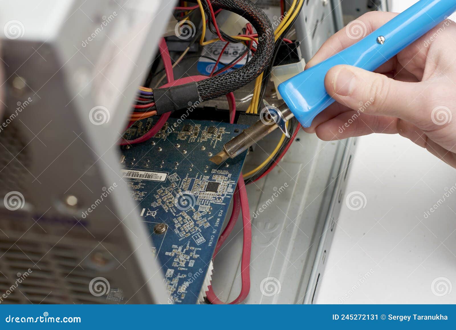 The Master Repairs the Old Computer Soldering the Chip with a Soldering