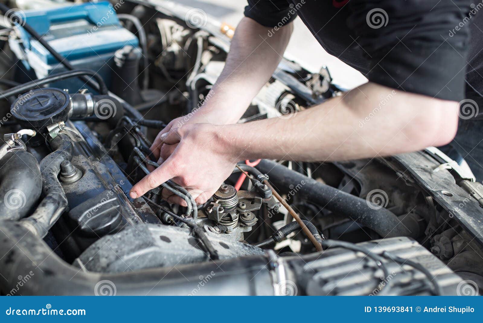 The Master Repairs Under the Hood of the Car Stock Image - Image of