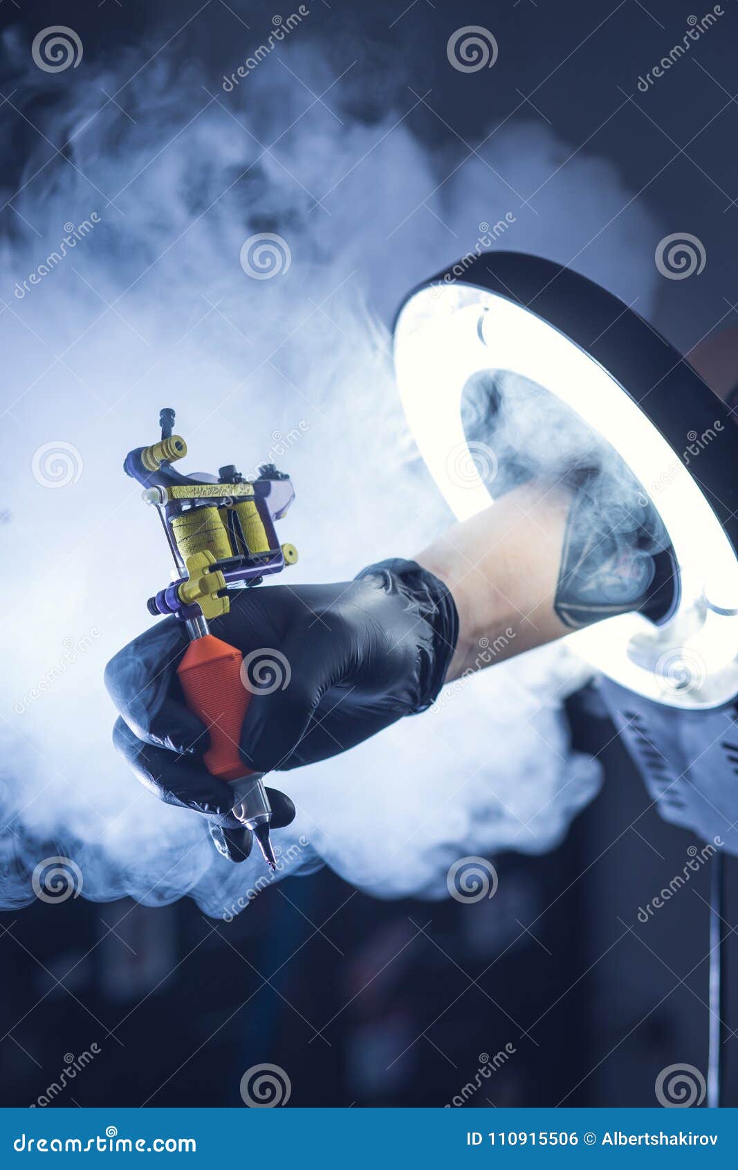 Master`s Hands Hold a Tattoo Machine. Stock Photo Image of background